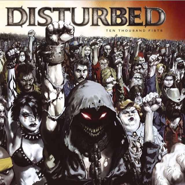 Illustrated crowd with raised fists surrounds a hooded figure with glowing red eyes beneath the title “Disturbed” and subtitle “Ten Thousand Fists”.