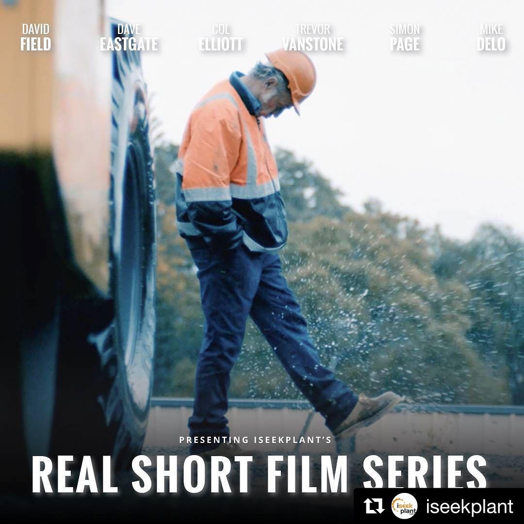 Construction worker in orange hard hat and high-vis jacket kicks up water beside a large vehicle, with film series text overlaid.