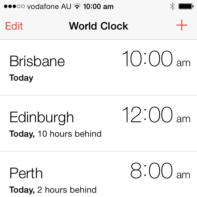 iPhone World Clock screen showing Brisbane 10:00 am, Edinburgh 12:00 am, and Perth 8:00 am, with Edit and plus buttons.