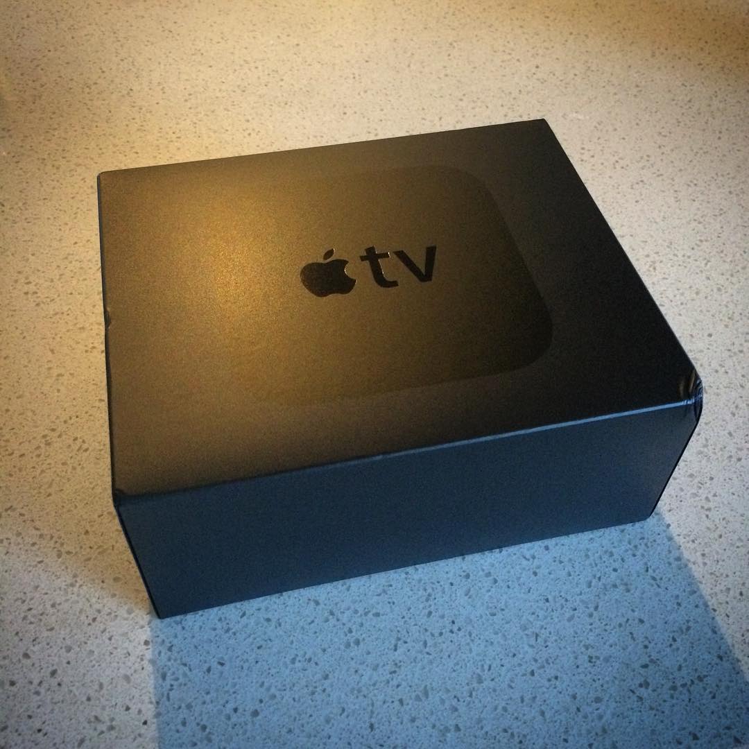 Black Apple TV box on a speckled countertop.