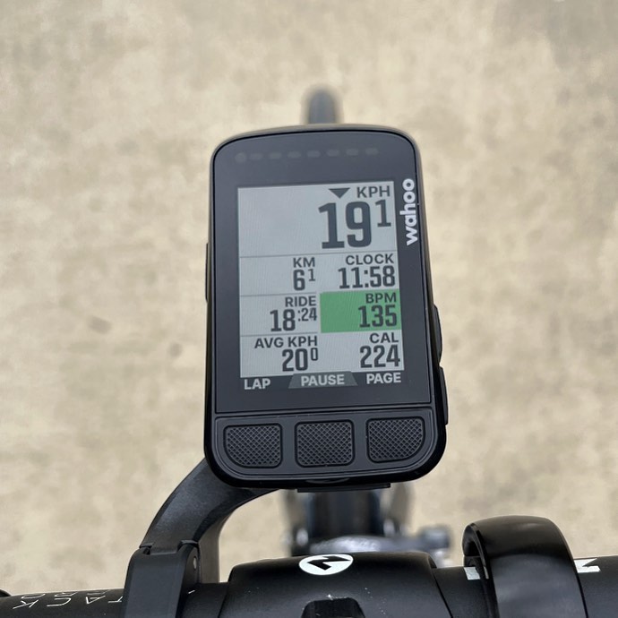 Bike computer on handlebars showing 19.1 kph, 61 km, 11:58, 18:24 ride time, 135 BPM, and 224 calories.