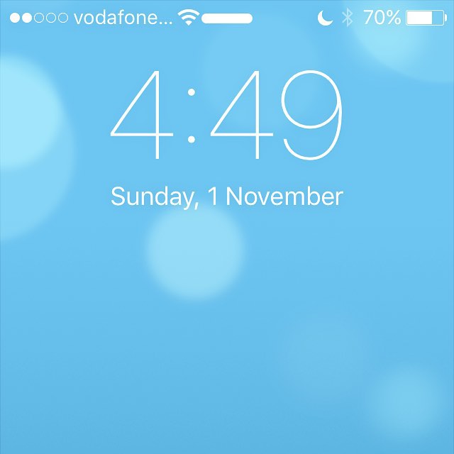 Phone lock screen showing 4:49, Sunday 1 November, Vodafone signal, Wi‑Fi, 70% battery, and a blue blurred background.
