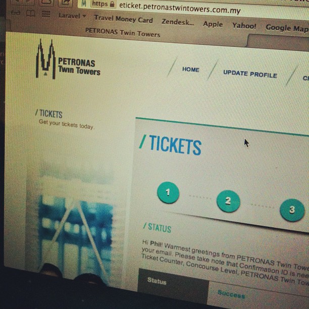 PETRONAS Twin Towers ticket booking webpage on a computer screen, showing ticket steps and a status message.
