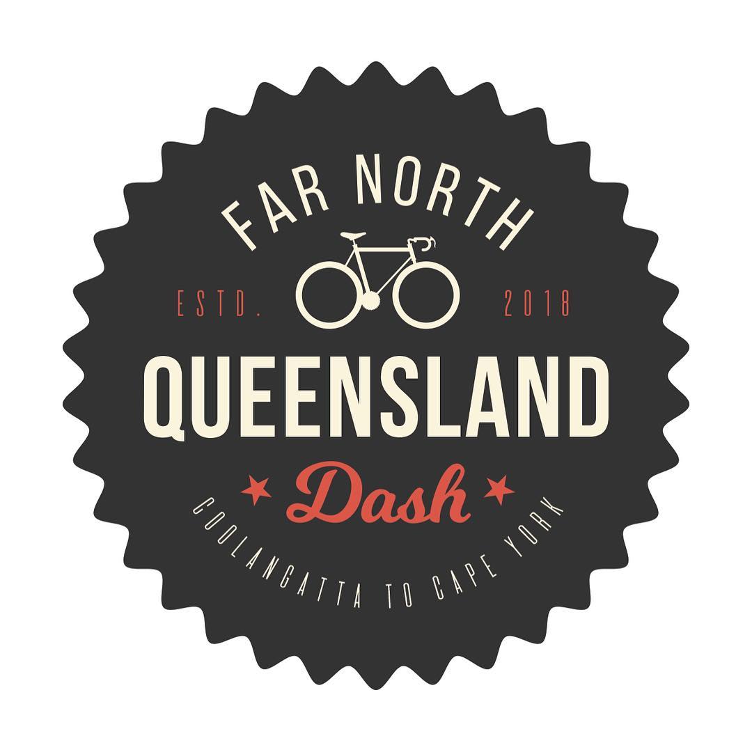 Circular black badge with bicycle icon and text: “Far North Queensland Dash,” “ESTD. 2018,” and “Coolangatta to Cape York.”