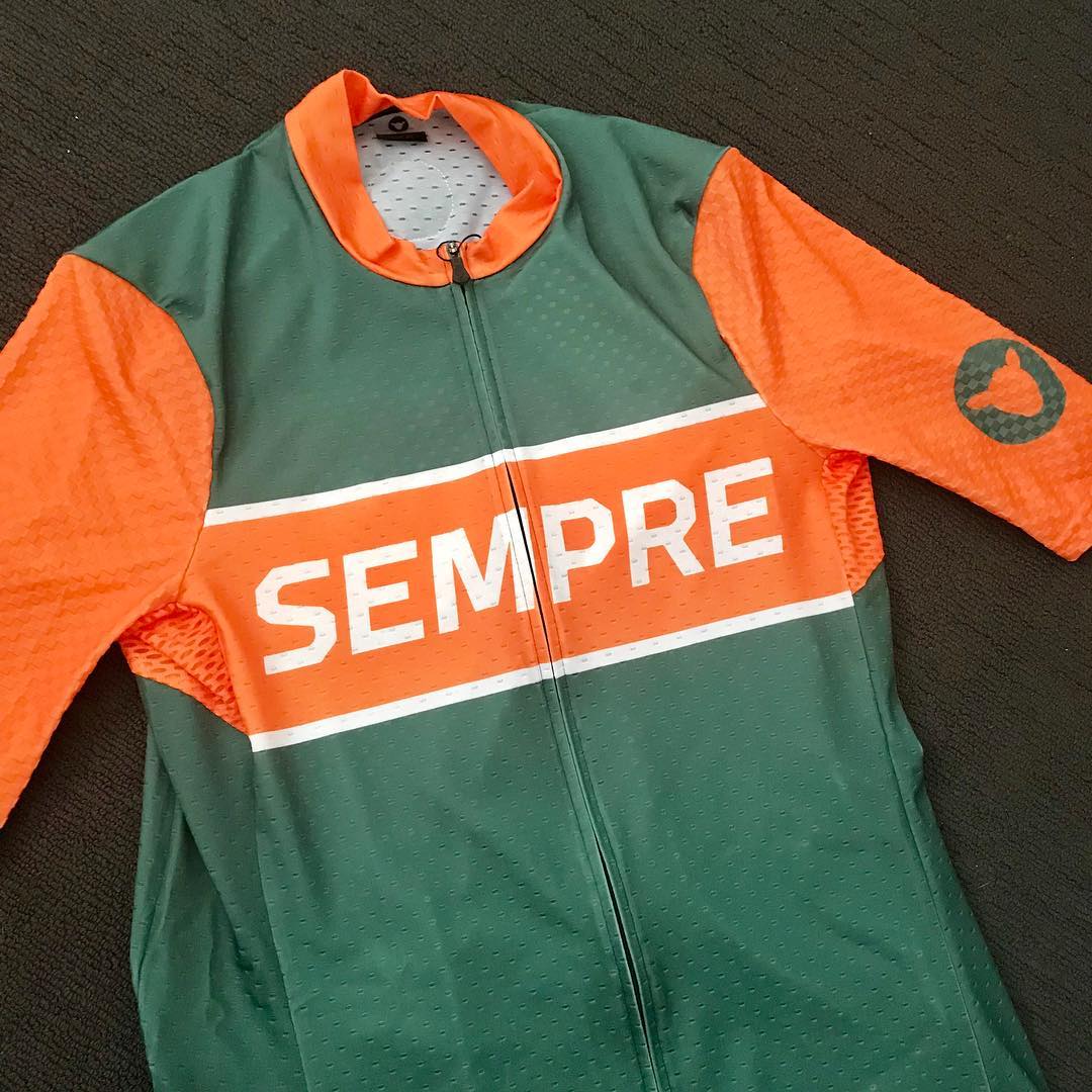 Green and orange short-sleeve cycling jersey with a front zipper and the word "SEMPRE" across the chest.