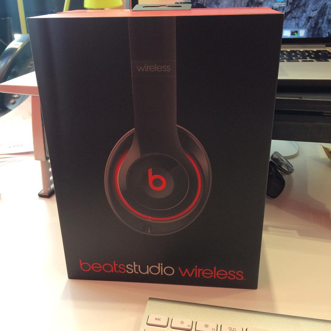 Black Beats Studio Wireless headphone box on a desk, with a laptop and keyboard partially visible in the background.