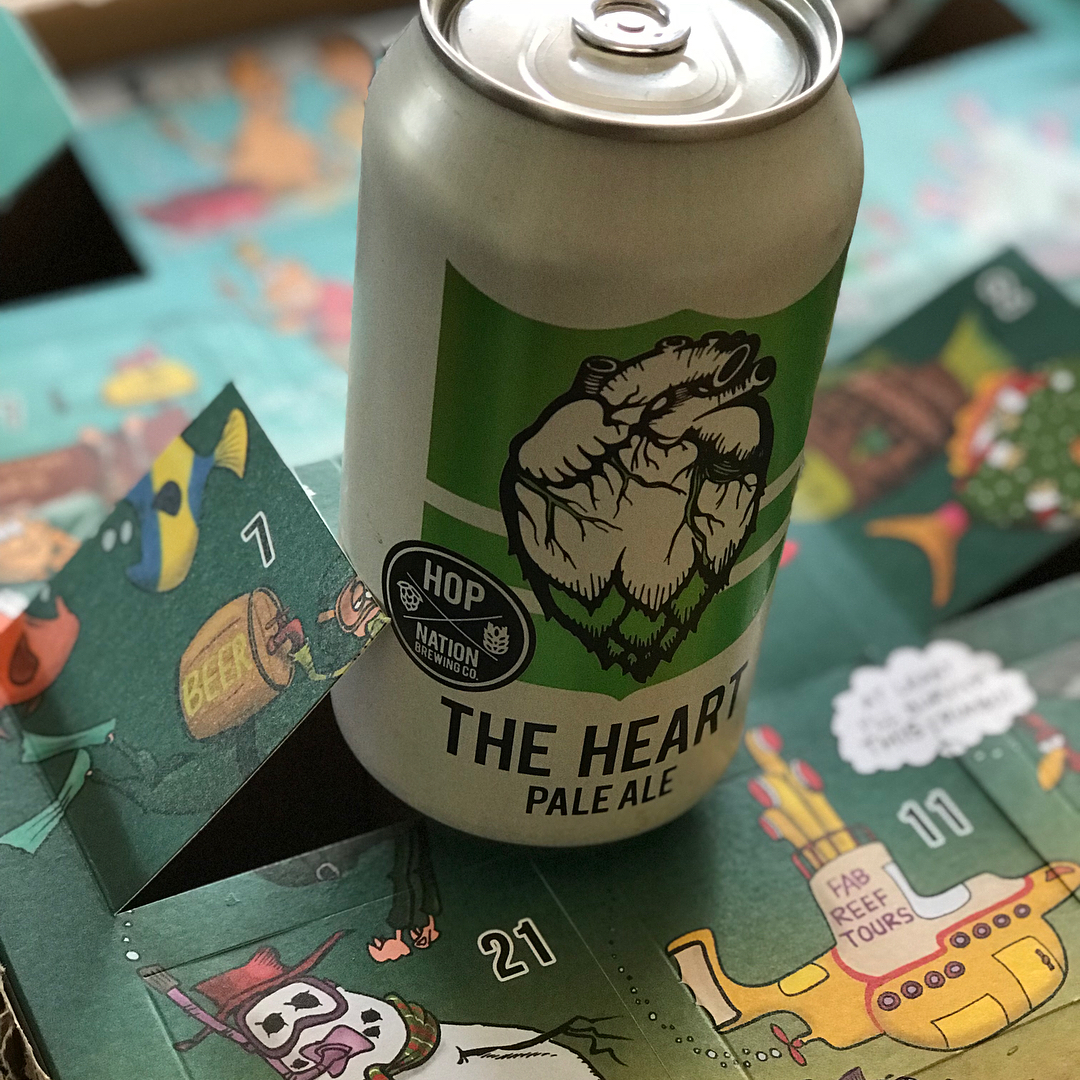 Can of The Heart pale ale on an illustrated advent calendar with numbered flaps open.