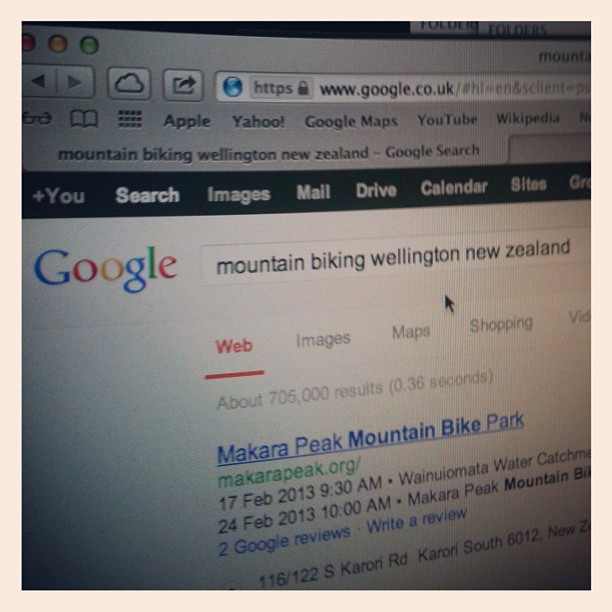 Laptop screen showing a Google search for “mountain biking wellington new zealand” with results including Makara Peak Mountain Bike Park.