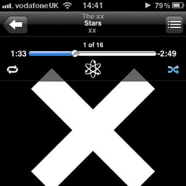 Music player screen showing The xx song "Stars xx" with playback controls and a large white X on a black background.